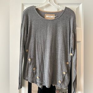 Grey sweater with tan elbow pads and tan buttons on the front